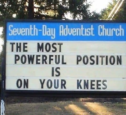 Church signboard from Seventh-Day Adventist Church reads: The most powerful position is on your knees.