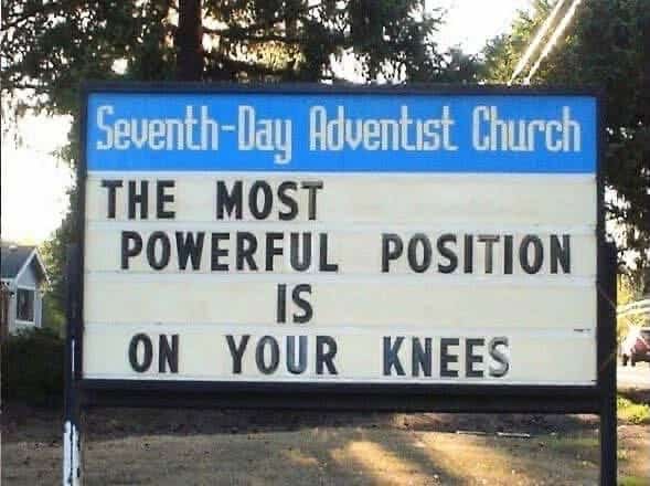 Church signboard from Seventh-Day Adventist Church reads: The most powerful position is on your knees.