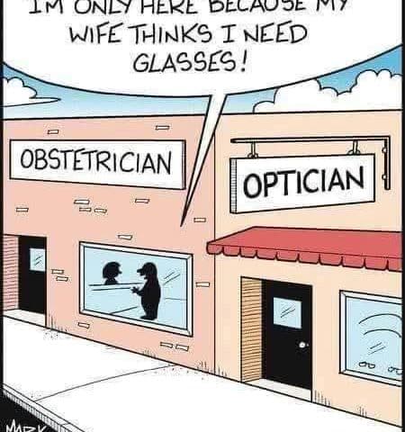 Two storefronts side by side labeled Obstetrician and Optician. A man inside says to a woman through a window, 'I'M ONLY HERE BECAUSE MY WIFE THINKS I NEED GLASSES!'.