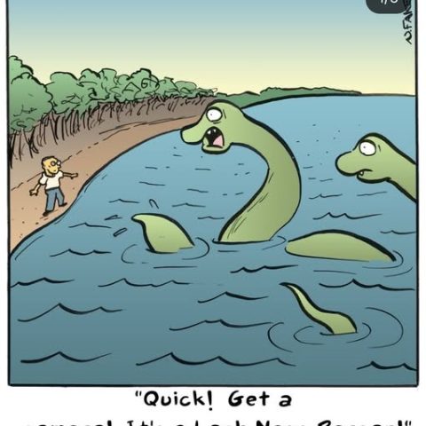 A cartoon shows a person standing on a shore pointing excitedly at a green creature with a long neck and a human-like face emerging from the lake water, with one more similar creature partially visible in the background.