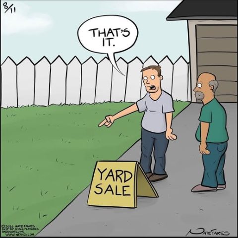 Two men stand next to a yard sale sign in front of a white picket fence and lawn; one man points at the grass saying 'That's it.'