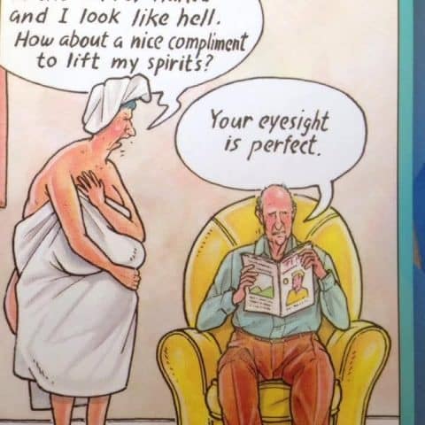 An elderly woman in a towel talks to an elderly man seated in a yellow armchair holding a magazine. The woman says she looks terrible naked and asks for a compliment, the man replies her eyesight is perfect.