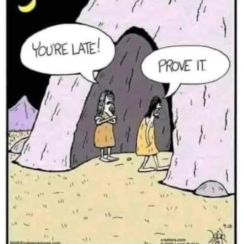 Two cave people standing outside a cave at night, one accusing the other of being late and the other replying 'Prove it'.