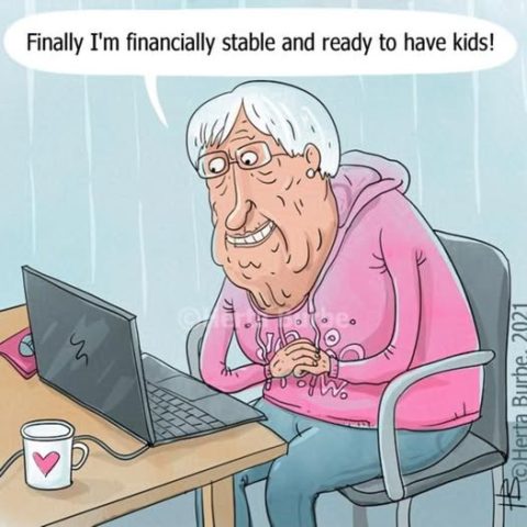An elderly person sitting at a desk in front of a laptop, wearing glasses and a pink hoodie, smiling and saying they're financially stable and ready to have kids.