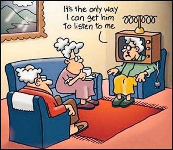 Cartoon of three elderly people in a living room, one woman is sitting with a TV set over her head with an antenna, saying 'It's the only way I can get him to listen to me' while the others sit on couches watching her.