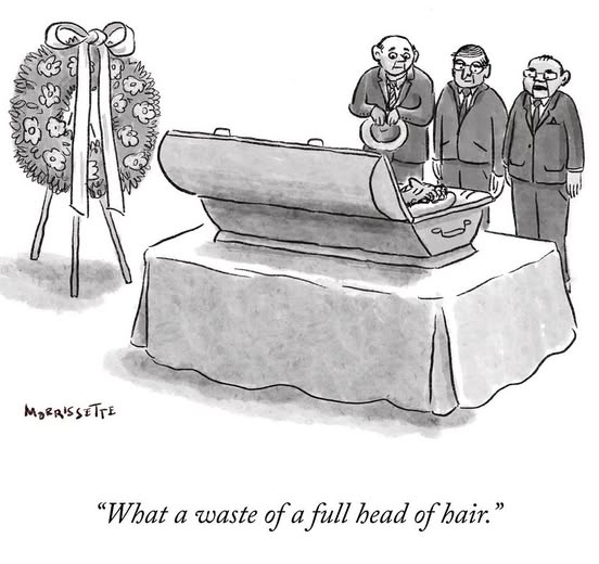 Three men in suits stand by an open coffin with a person inside visible from the scalp, and a floral wreath nearby.