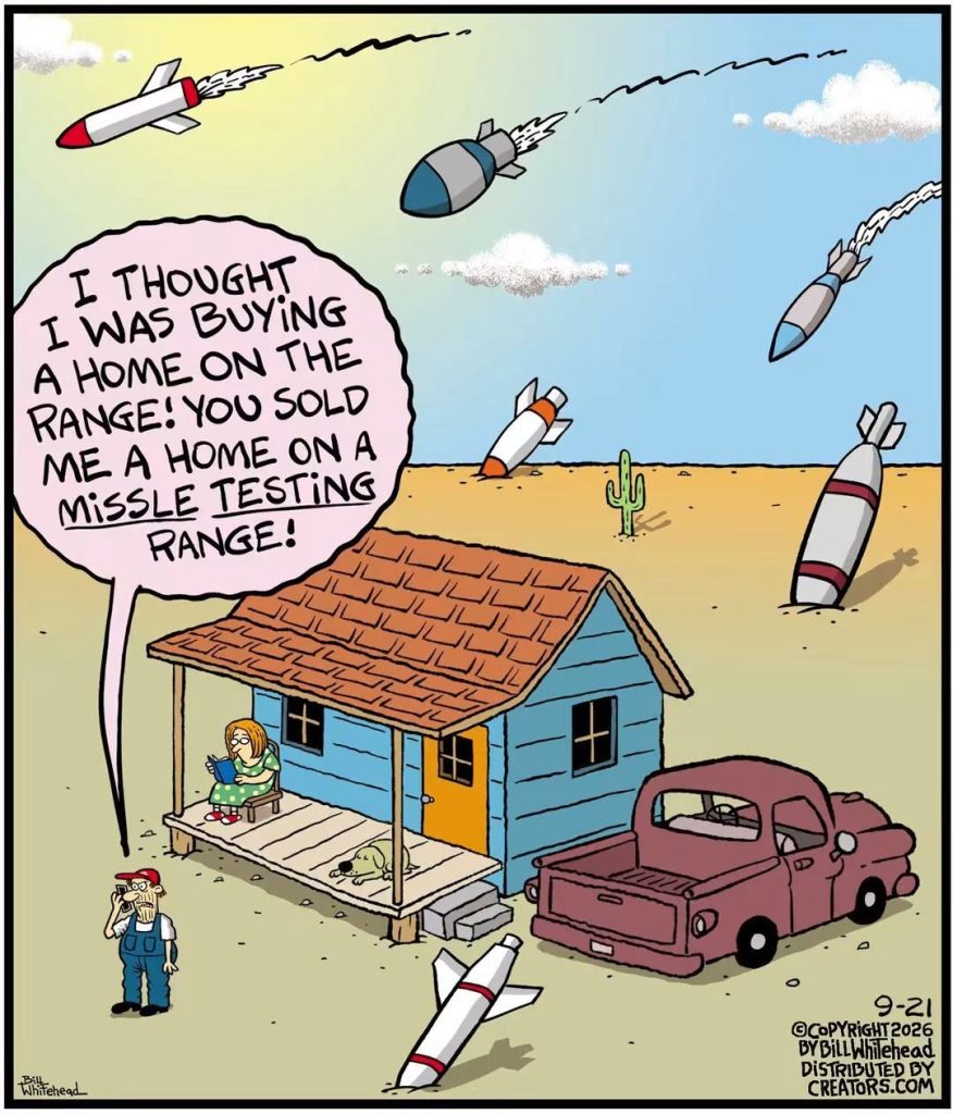 Man standing outside a blue house with a woman on the porch and missiles flying and crashing around them in a desert.