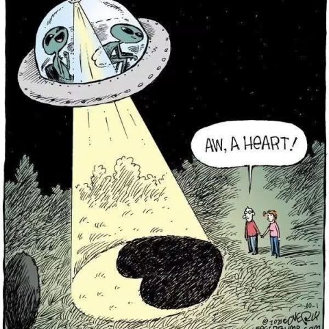 Two aliens inside a UFO shine a spotlight down onto a heart-shaped crop circle, while a couple nearby notices and comments on the heart shape.