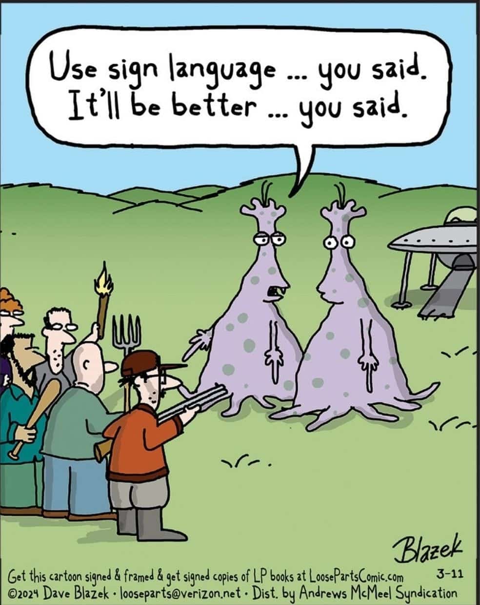 Two purple aliens with antennae stand on a grassy field. One alien has a speech bubble saying, 'Use sign language ... you said. It'll be better ... you said.' They face a mob of angry people holding weapons, with a UFO in the background.