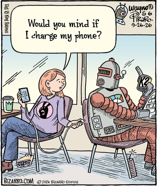 Woman sitting in a chair plugging her phone charger into the back of a robot who's also seated and reading a tablet while holding a drink.