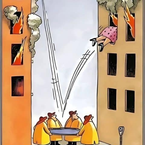 Four firefighters in yellow coats holding a safety net between two burning buildings as a woman jumps out of a window.