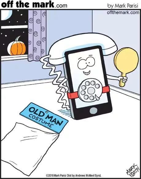 A smiling smartphone wearing a rotary phone dial and an old handset as a Halloween costume, holding a mirror, with a pumpkin on the window sill and a bag labeled 'Old Man Costume' on the floor.